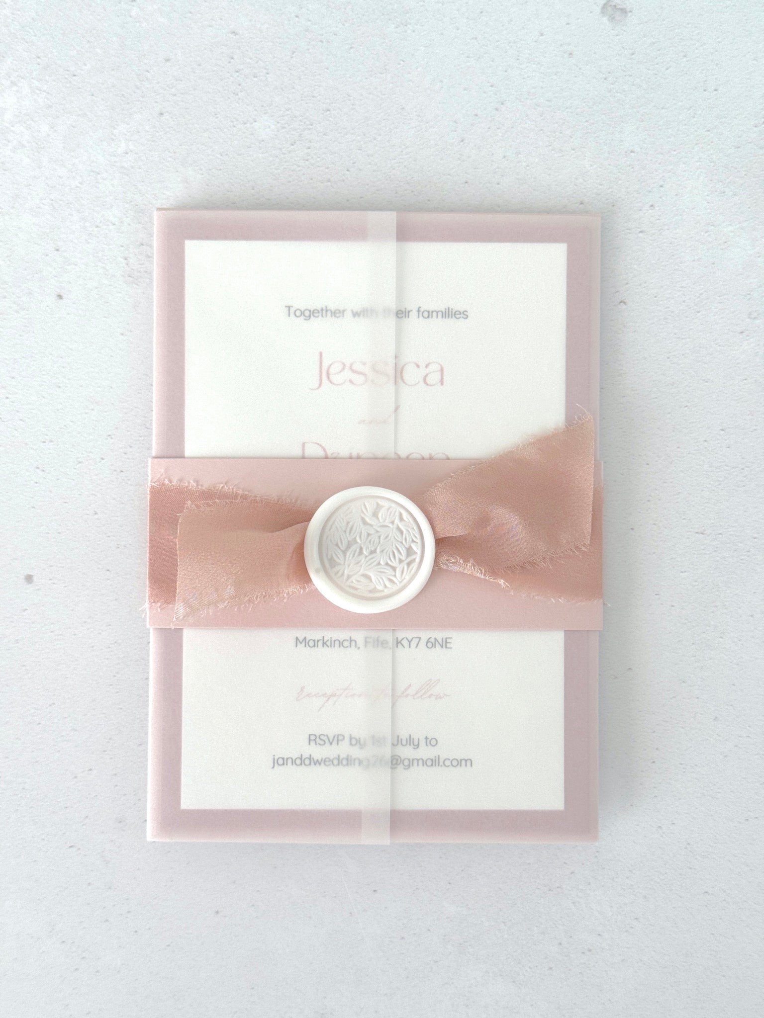 Pink wedding invite with see thru paper and belly band with wax seal