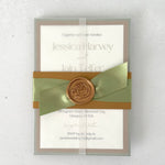 transparent wrapped wedding invite with belly band and wax seal in sage green and gold