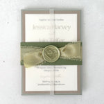 see through paper wrap with sage green silk ribbon and wax seal belly band wedding invite