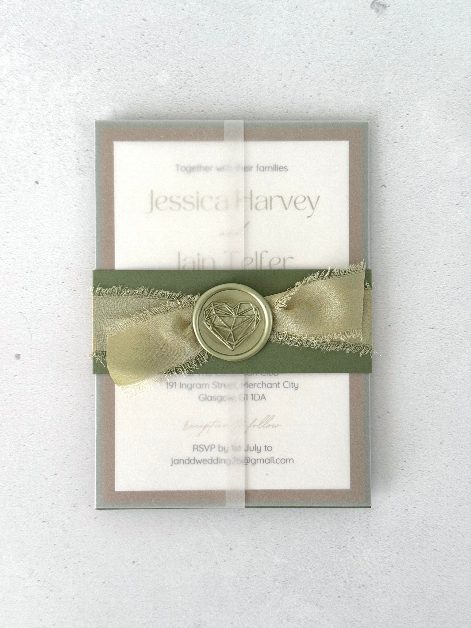 see through paper wrap with sage green silk ribbon and wax seal belly band wedding invite