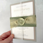 Lyn vellum wrap wedding invite with sage green silk ribbon and wax seal belly band