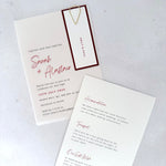 Vellum wedding invite with burgundy name tag and paperclip, with details card for wedding info and gift wish