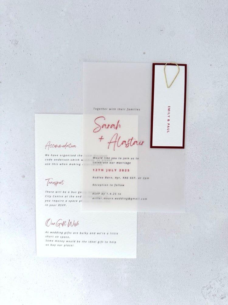 transparent vellum wedding invite with sage green name tag and teardrop paperclip and details card for accommodation and transport