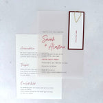 transparent vellum wedding invite with sage green name tag and teardrop paperclip and details card for accommodation and transport