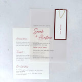 transparent vellum wedding invite with sage green name tag and teardrop paperclip and details card for accommodation and transport