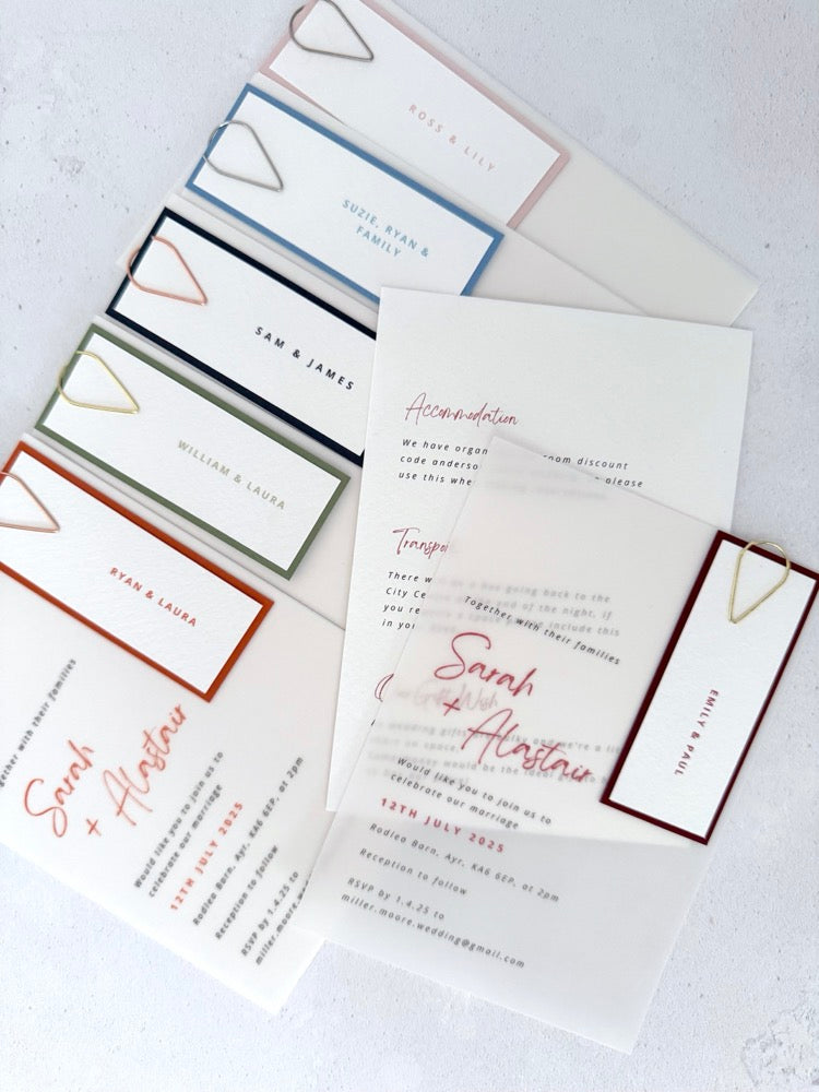 Handmade see through vellum wedding invites with coloured tags and teardrop paperclip in 6 colours