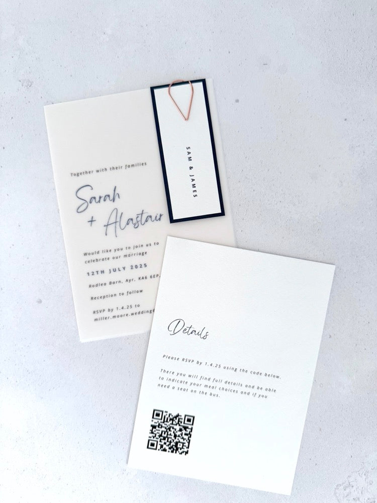 Vellum wedding invite with navy name tag and paperclip, with details card and QR code