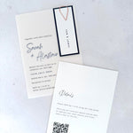 Vellum wedding invite with navy name tag and paperclip, with details card and QR code