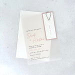 Sarah transparent vellum wedding invite with pink name tag and teardrop paperclip 