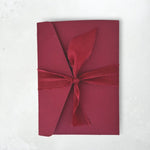 burgundy Zoe pocketfold wedding invite with silk tied ribbon handmade by zara scotland