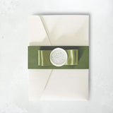 zoe sage green satin double bow and wax seal pocketfold wedding invite with belly band